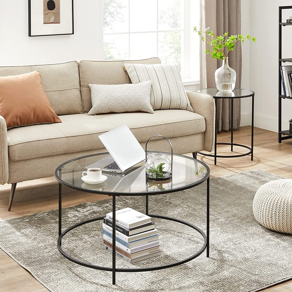 Rundt salongbord med glassplate og svart stålramme